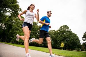Low angle photo of young couple  jogging outdoor in park
